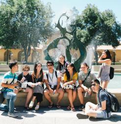 Participants sit beside a Stanford fountain.