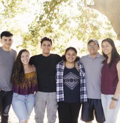 A group of participants stand together near Lake Lagunita.