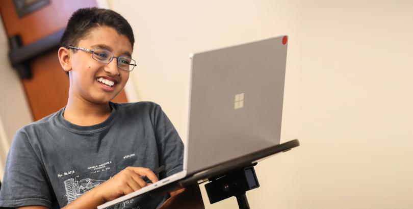 SMSSP student in front of computer